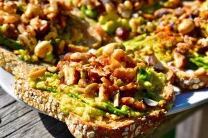 toast with smashed avocado and nuts