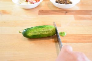 Cutting blossom end off of cucumber