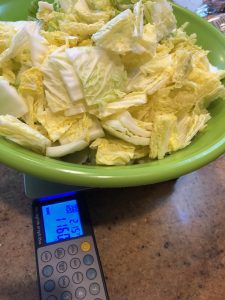bowl full of cut cabbage on scale weighing 1160 grams