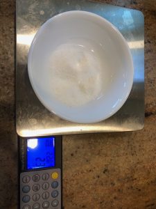 salt in bowl on scale weighing 23 grams
