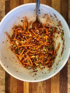 vegetables and seasonings mixed together in bowl