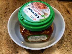 container of kimchi sitting in bowl