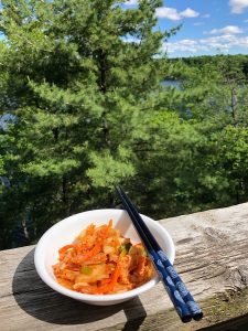 bowl of kimchi with chopsticks