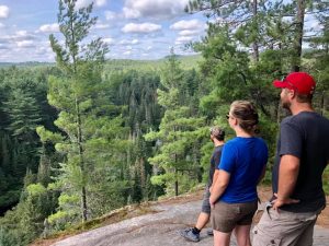 three hikers overlooking scenic view