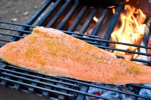 salmon fillet cooking over fire