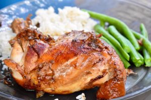 chicken adobo with beans and rice on plate