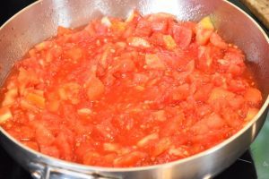 a large pot with lightly cooked diced tomatoes
