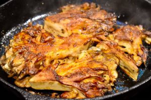 golden and crispy maitake mushrooms in a cast iron pan