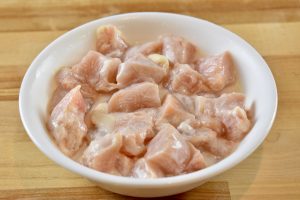 raw chicken in a bowl dressed in a cornstarch slurry