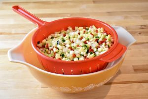 chopped vegetables draining in colander