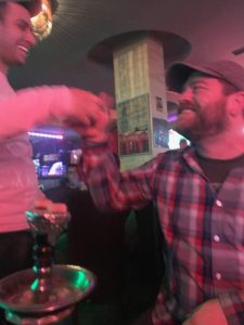 2 men shaking hands in a shisha bar