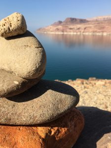 stacked rocks in front of the dead sea