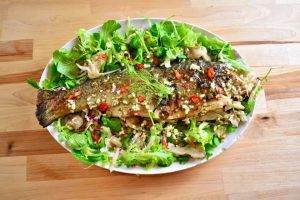 whole roasted fish on a bed of lettuce