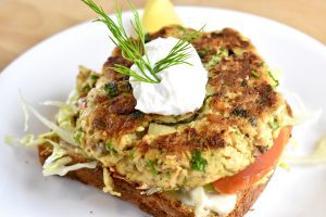 crispy salmon patty on an open faced sandwich