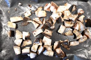 raw mushrooms on baking sheet