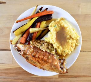 stuffed turkey wings with carrots, mashed potatoes, and gravy