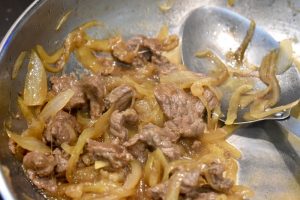 bison and onions in pan