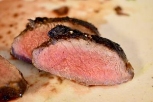 sliced medium rare venison steak